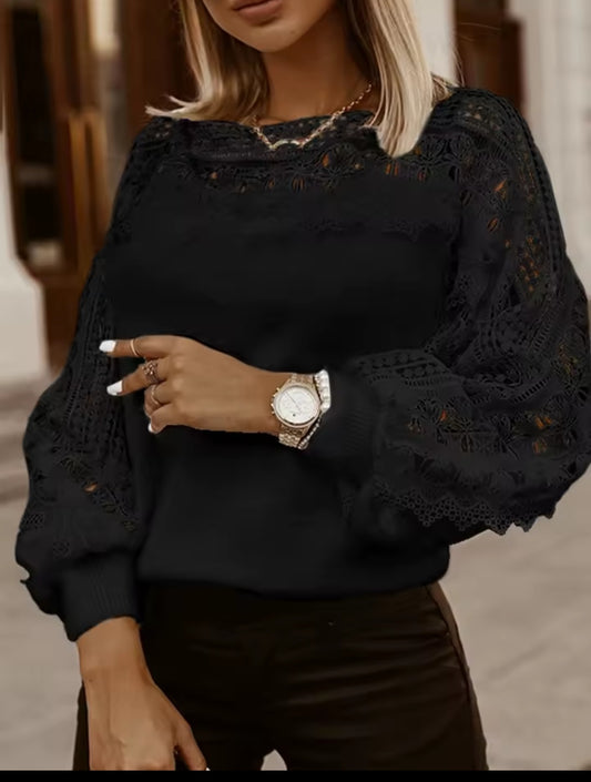 Black lace-sleeve top worn by a person, with a neutral background