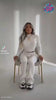 video of model sitting in a chair in a winter set with AI next to her