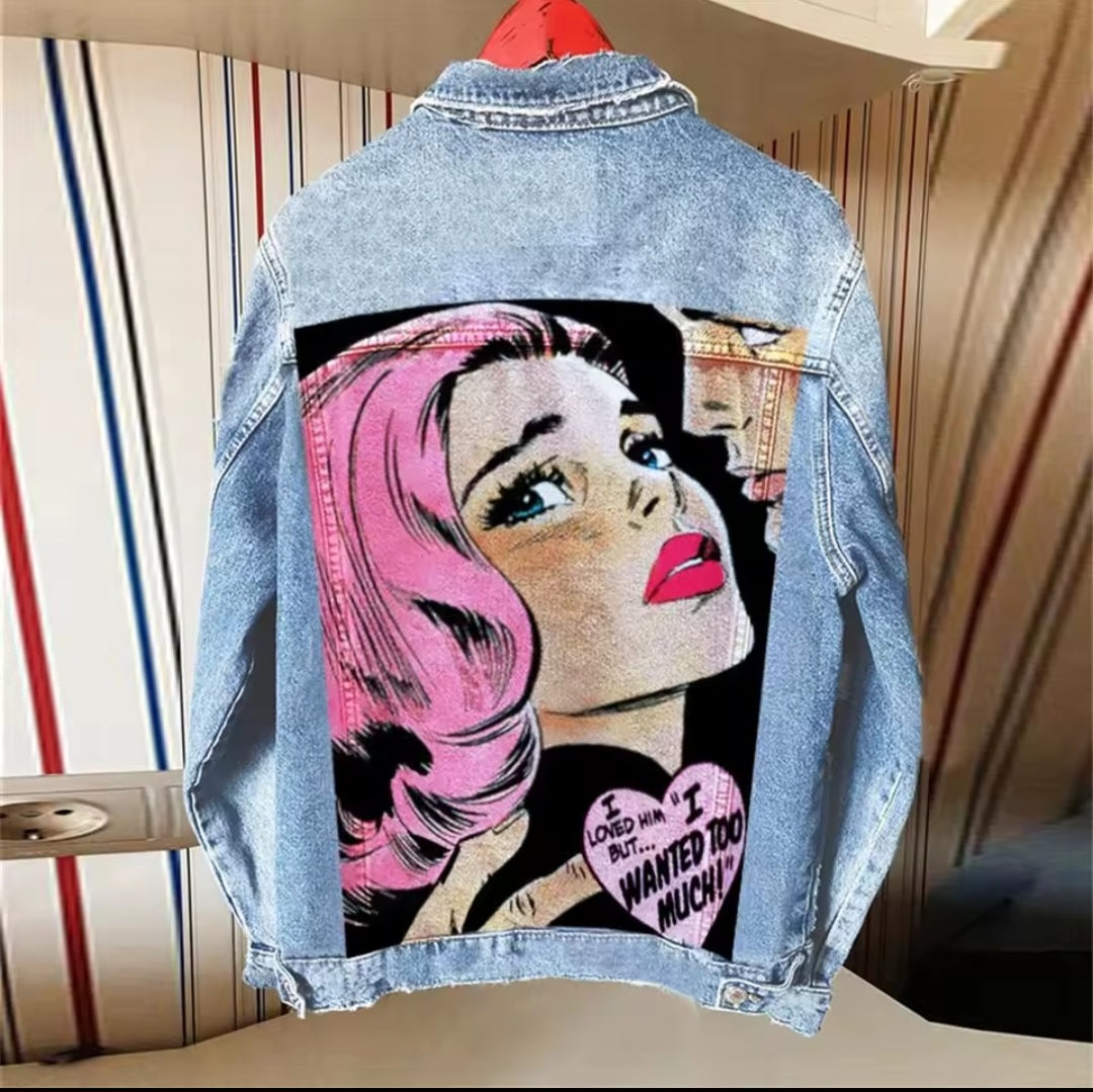 Denim jacket with a graphic design of a woman's face and text on a striped background