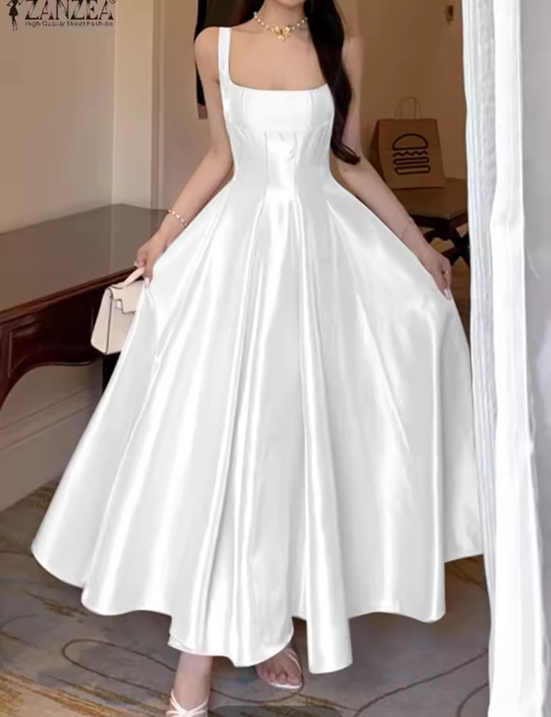 Woman wearing a white dress in an indoor setting