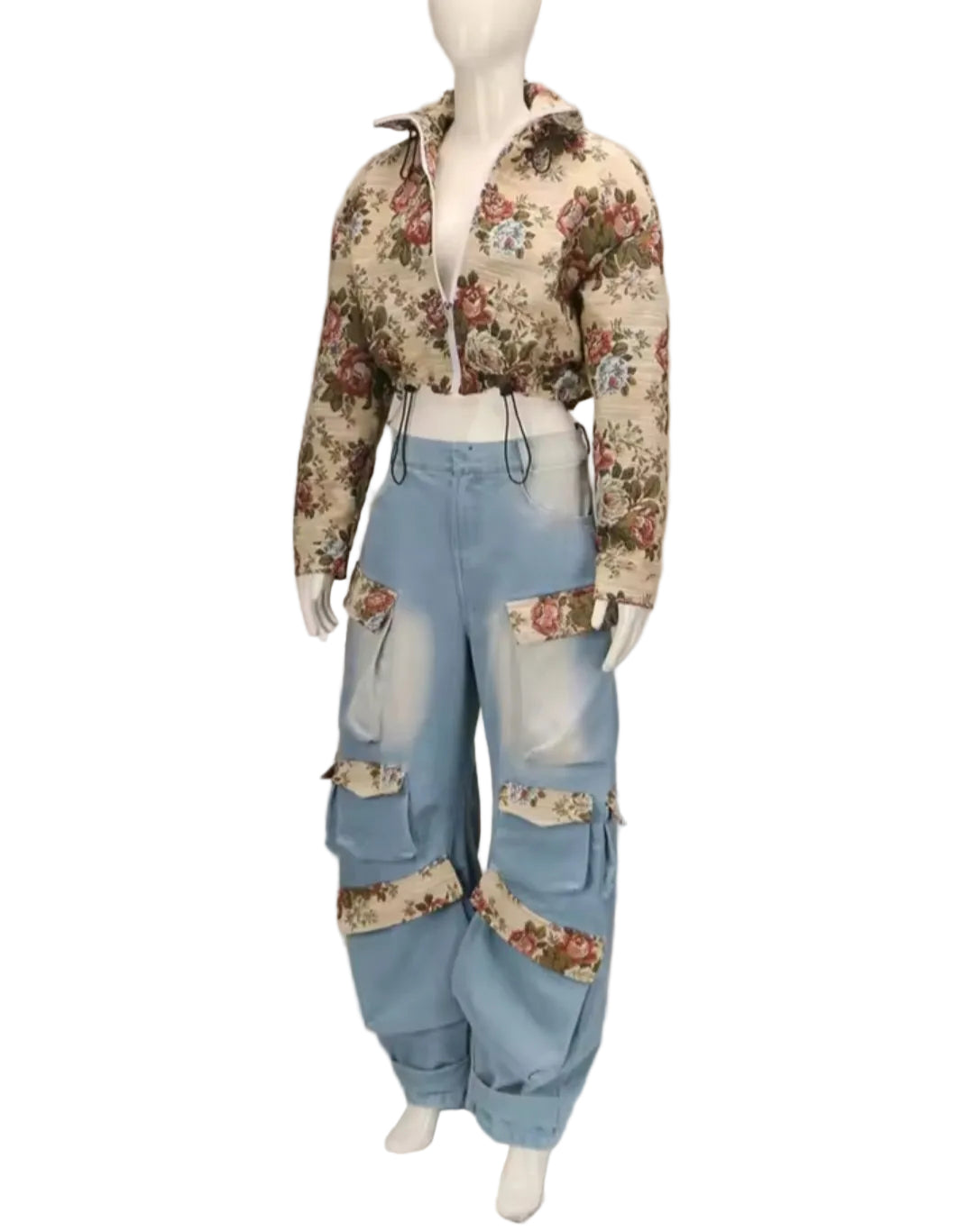 Mannequin wearing a floral top and patchwork jeans on a plain background