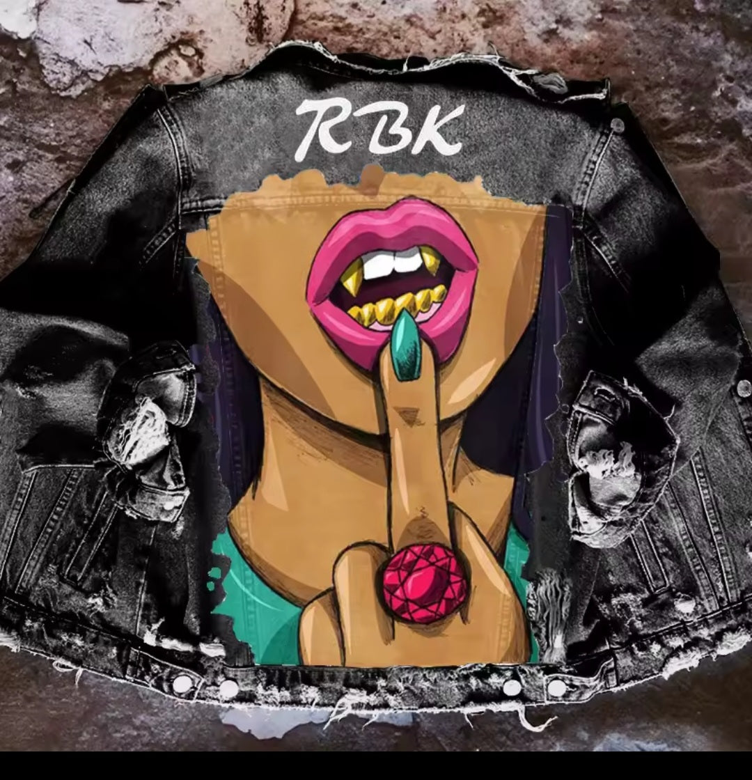 Denim jacket with a graphic design of a stylized face and 'RBK' branding.