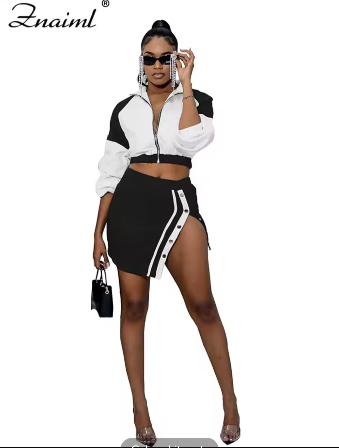 Woman wearing a black and white outfit with 'Znaiml' branding.