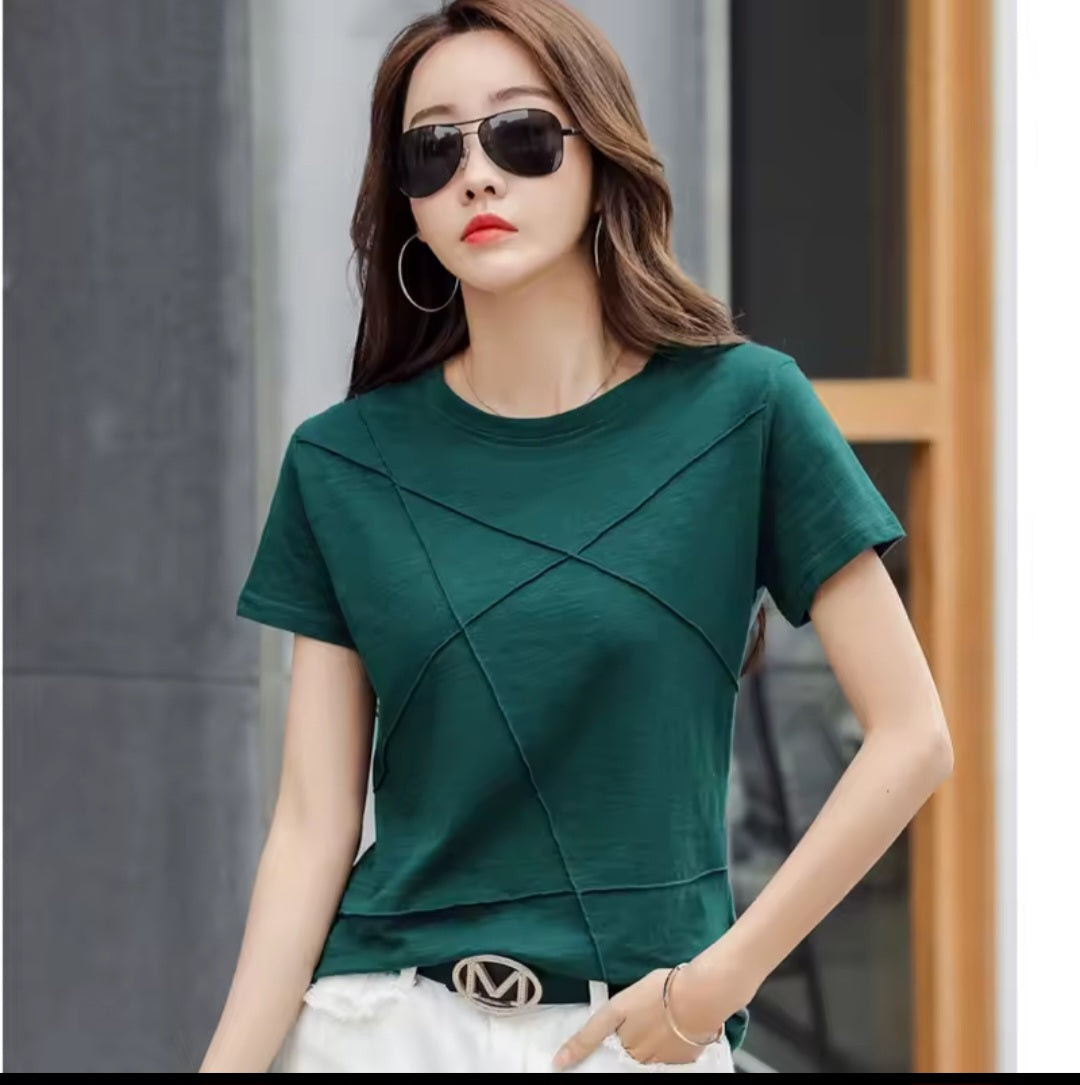 Woman wearing a green top with a blurred background