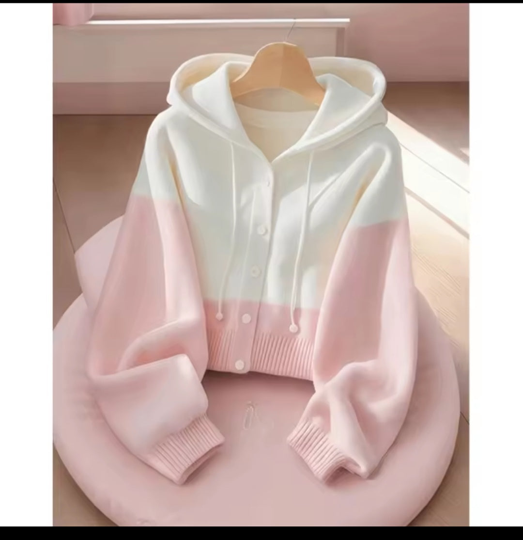 White and pink gradient hoodie on a wooden hanger against a soft pink background
