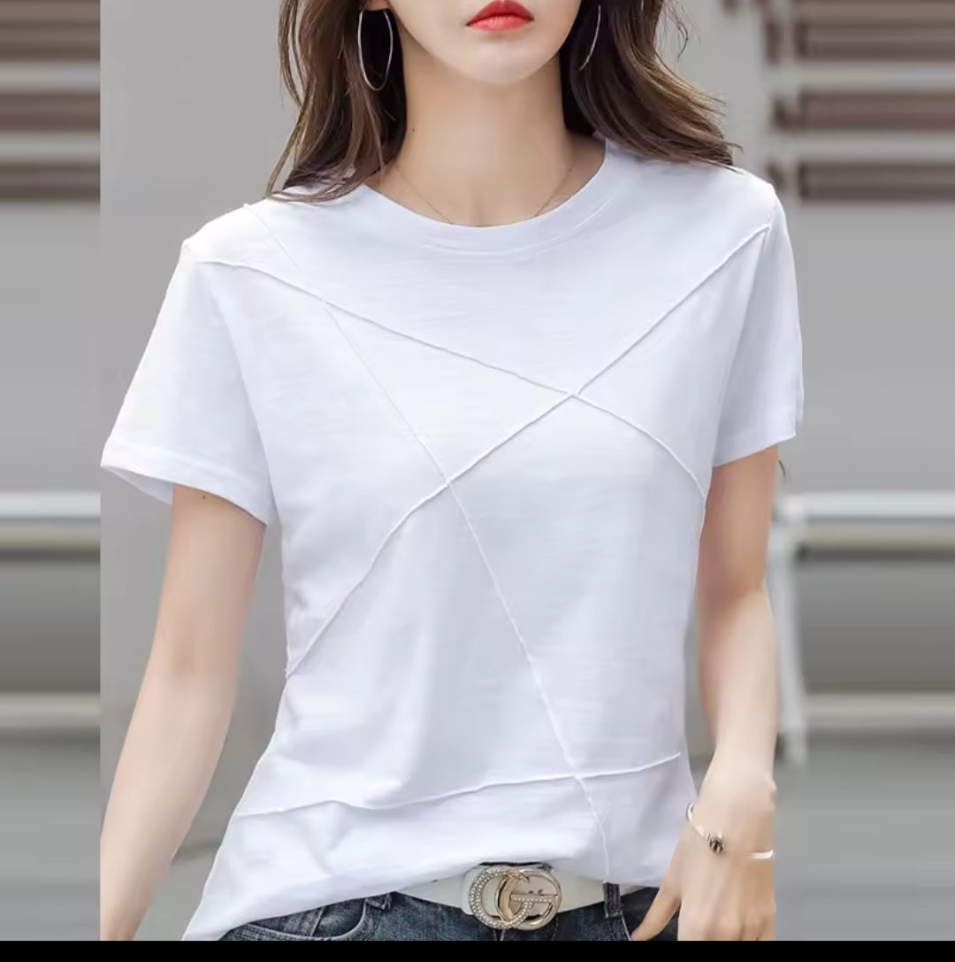 White t-shirt worn by a person with a blurred background