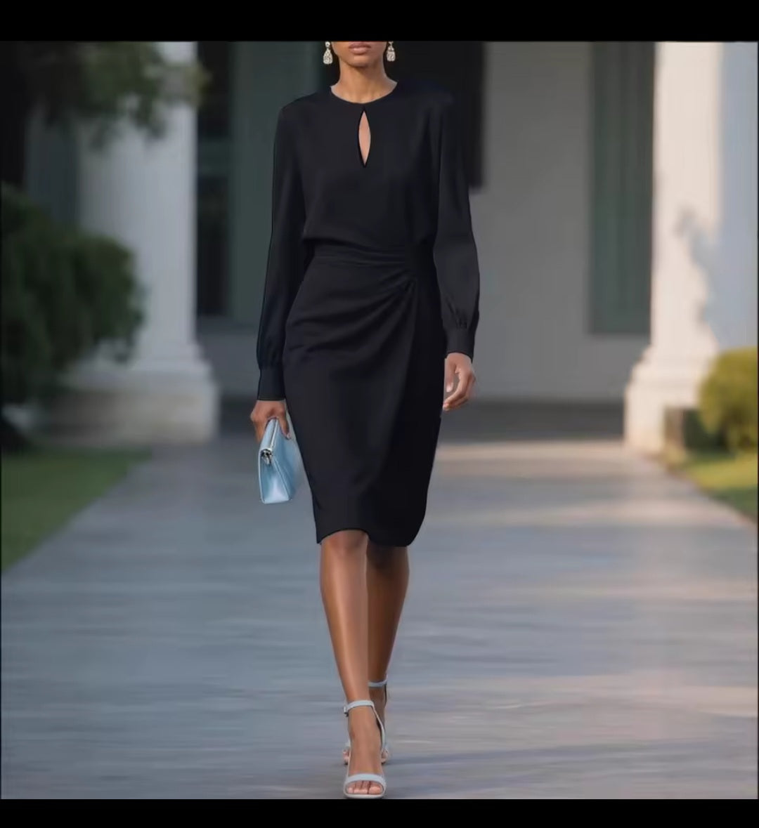 Woman in a black dress walking outdoors with columns in the background