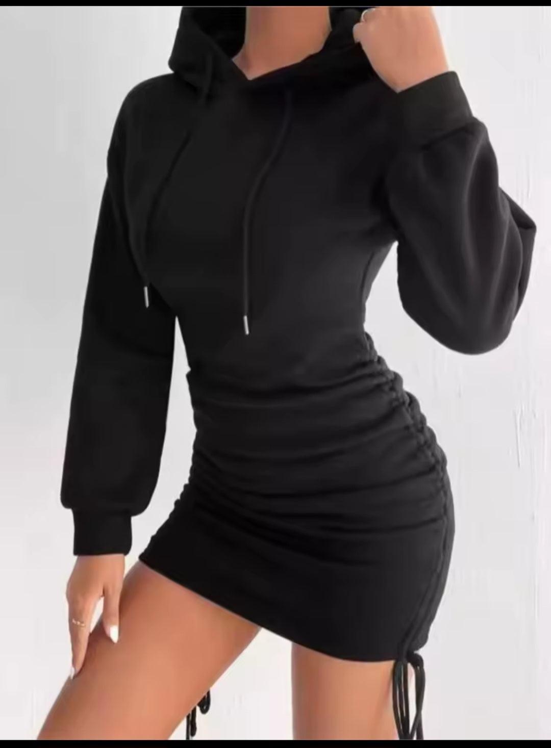 Black hoodie dress worn by a person on a white background