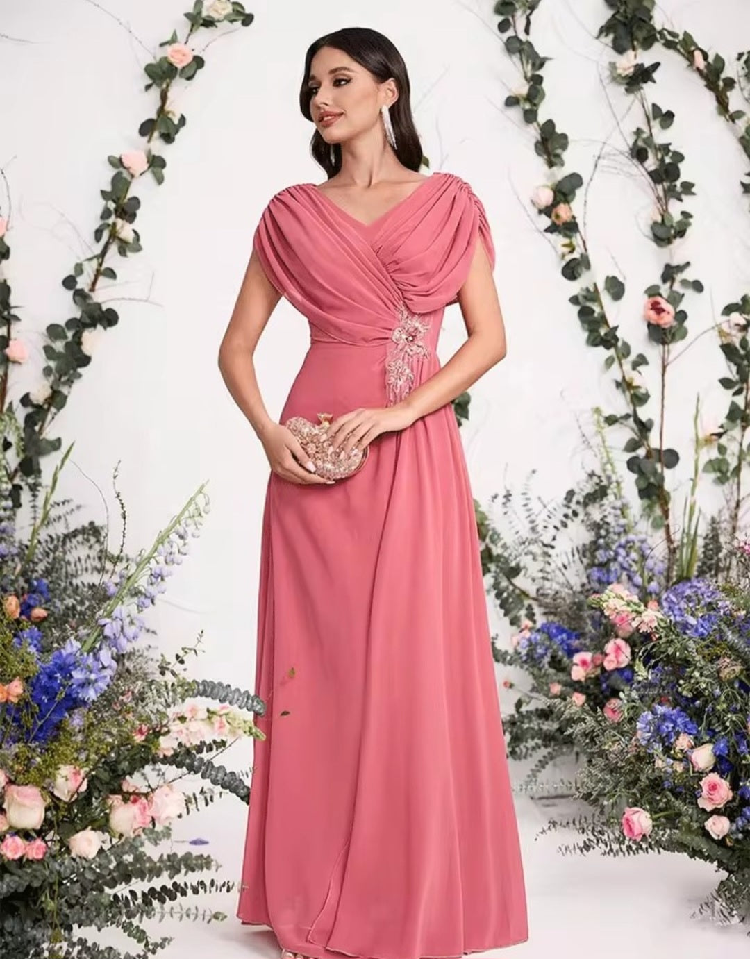 Woman in a pink dress standing among floral decorations