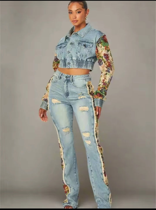 Person wearing a denim outfit with floral sleeves on a gray background