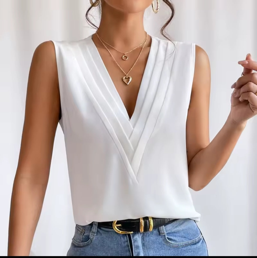 White sleeveless top worn by a person on a white background