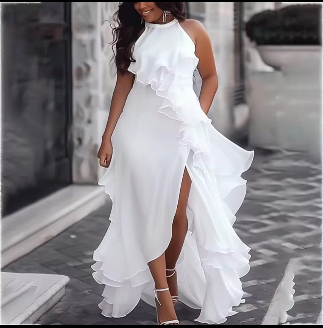 Woman wearing a white ruffled dress on a blurred street background