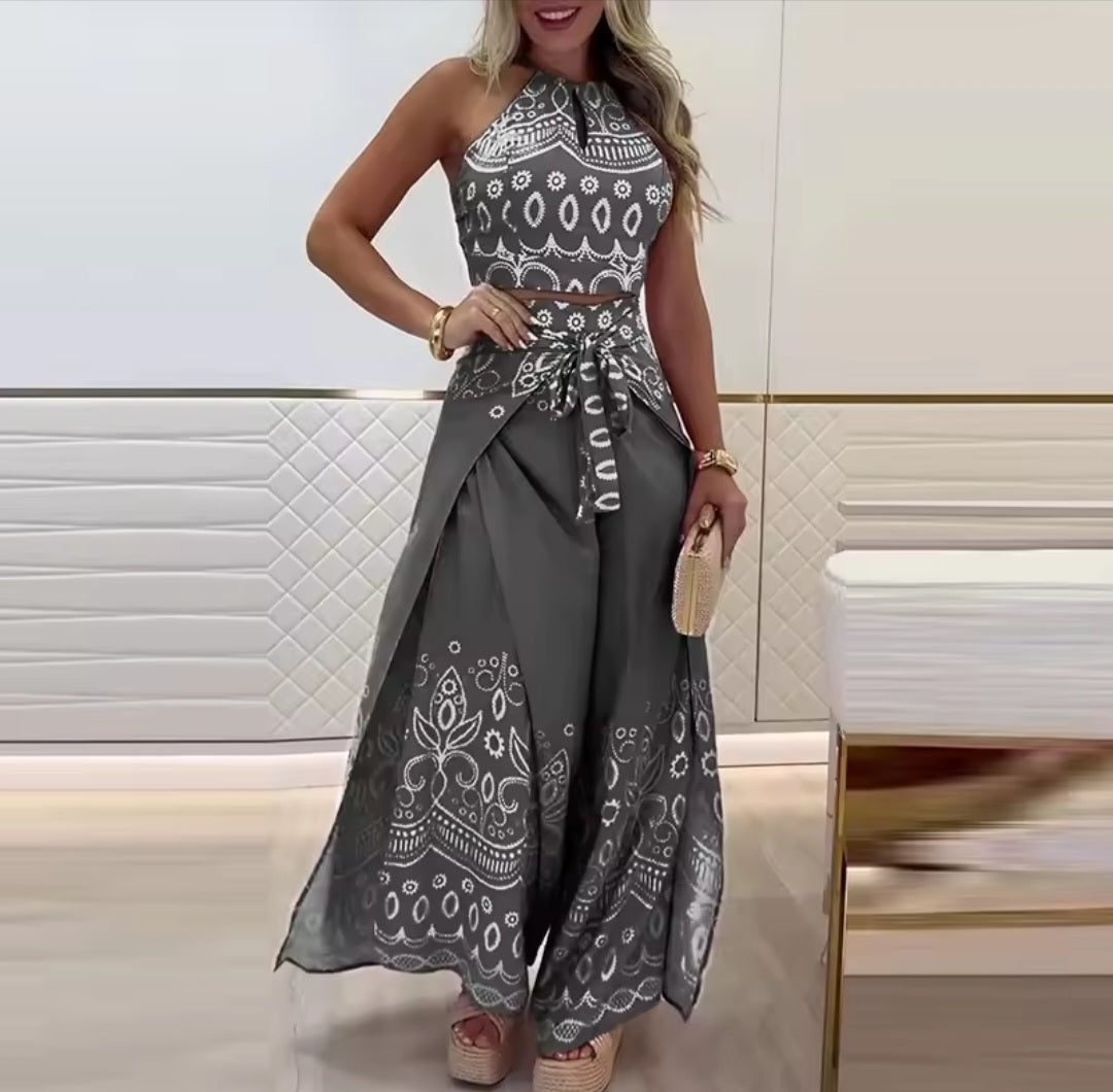 Woman wearing a gray and white patterned dress in an indoor setting.