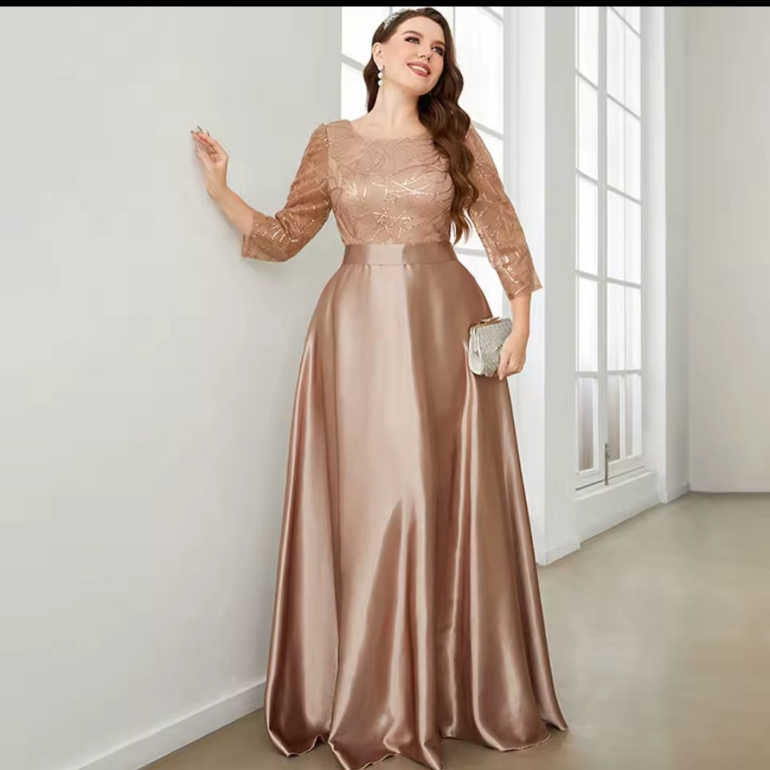 Woman wearing a rose gold evening gown with a plain white background