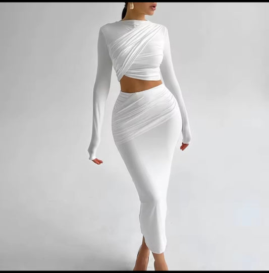 White long-sleeve top and skirt set on a plain background
