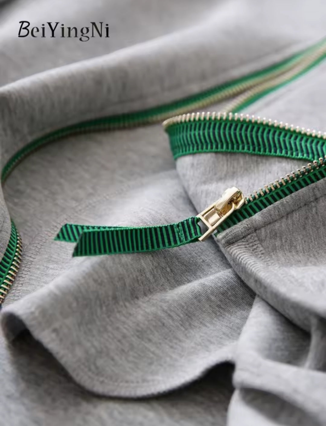 Gray fabric with green zipper and 'BeiYingNi' branding.