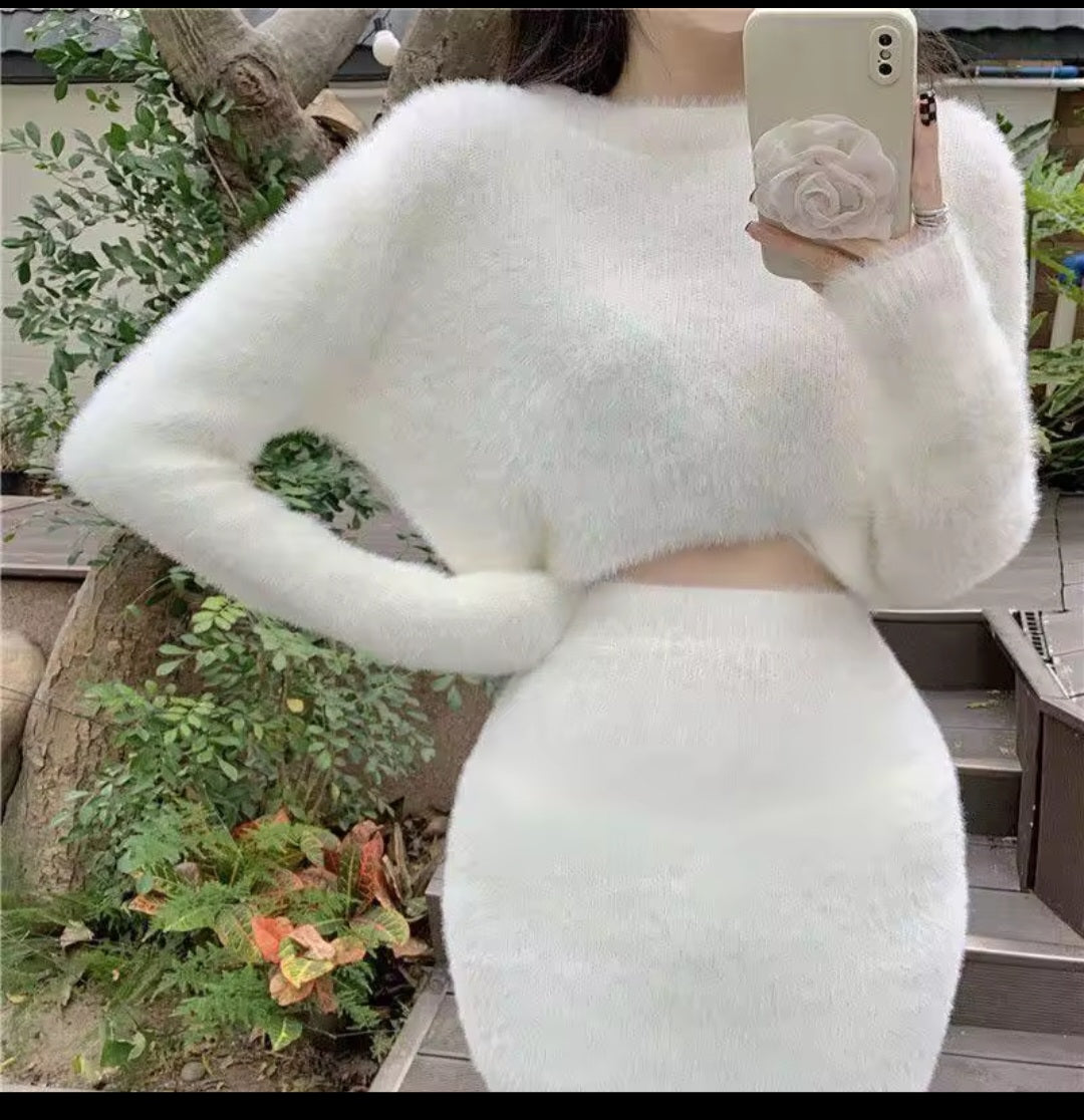 Person wearing a white textured outfit taking a mirror selfie outdoors.