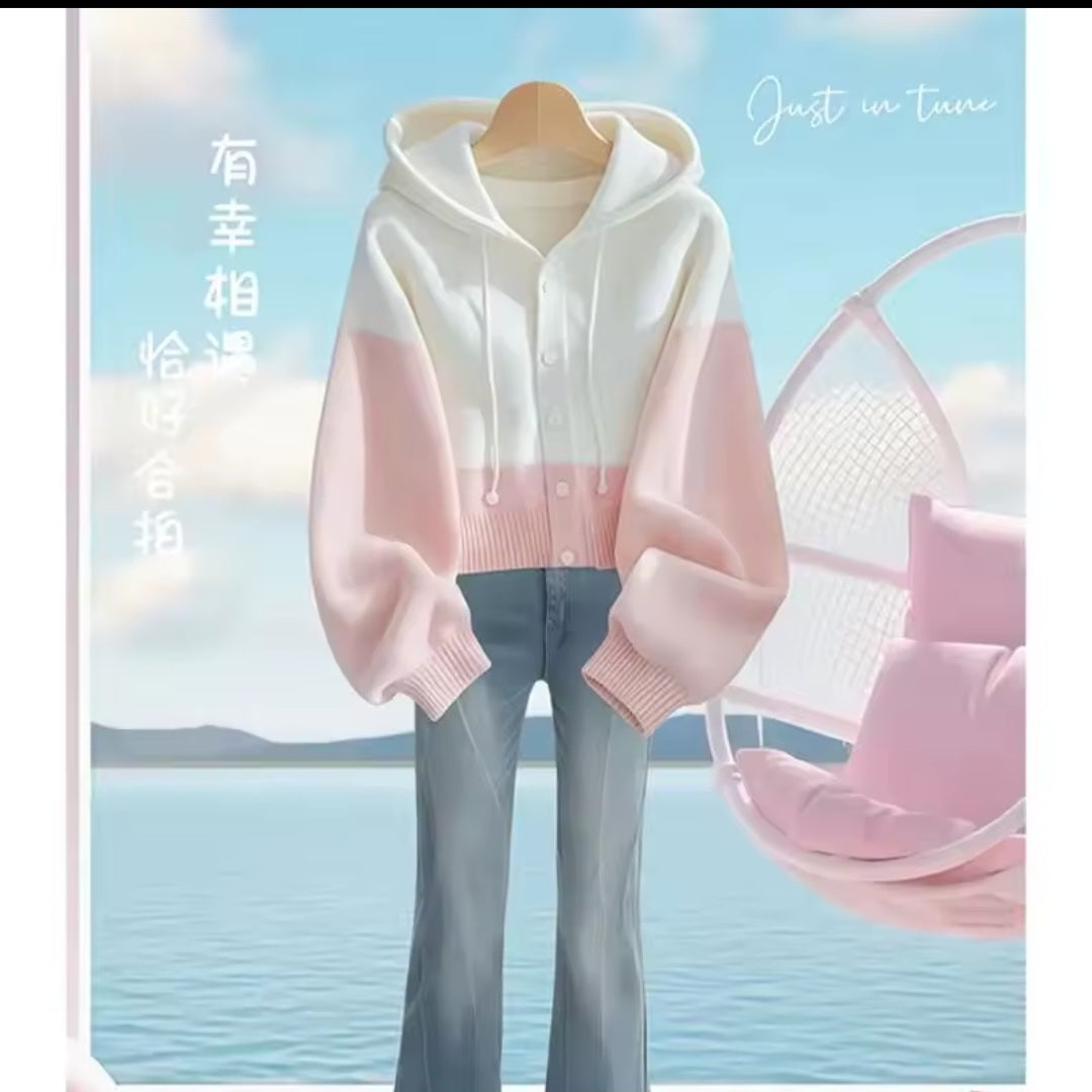 White and pink hoodie with a blurred scenic background
