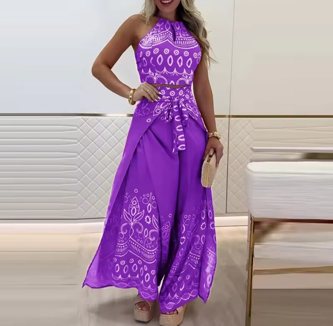 Woman wearing a purple dress with white patterns in an indoor setting