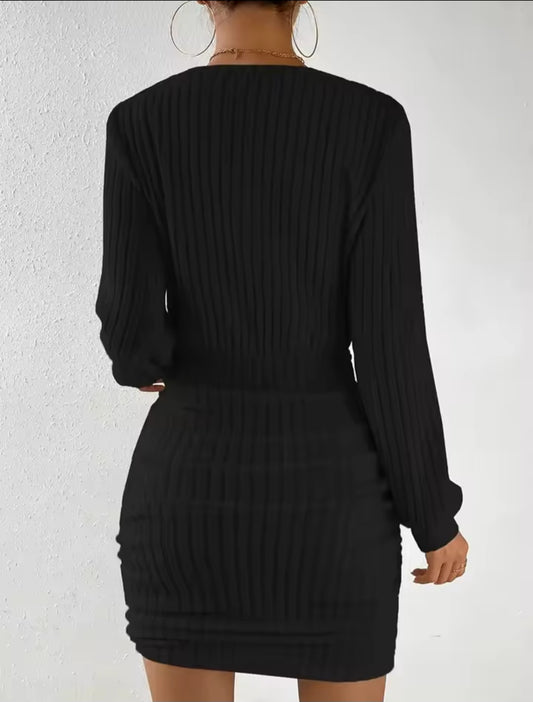 Black ribbed dress worn by a person on a white background