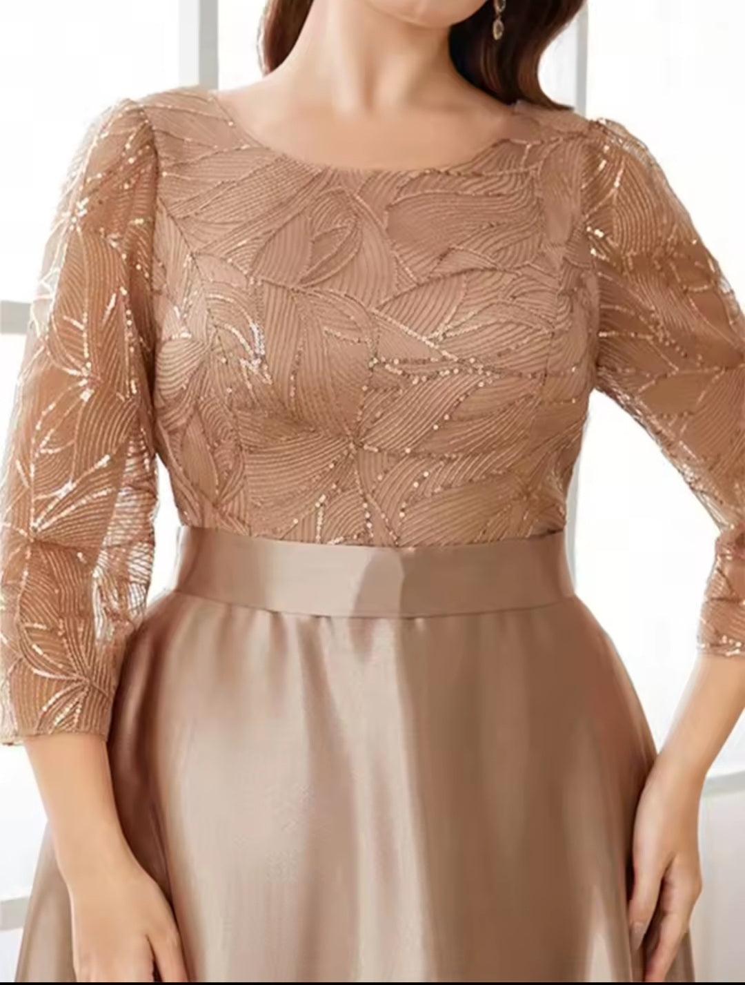 Brown dress with a textured top and satin skirt on a white background