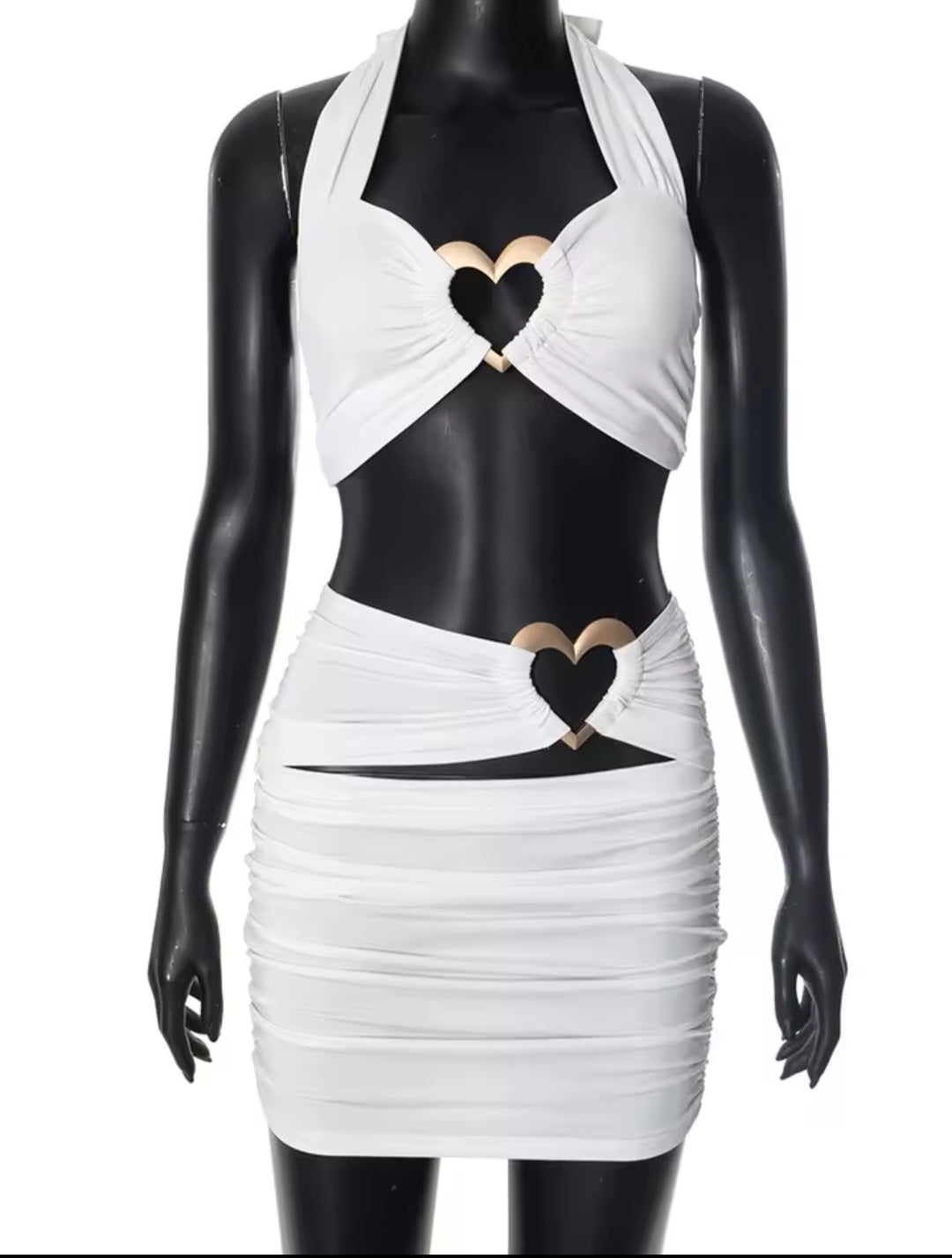 White dress with black heart designs on a mannequin against a white background