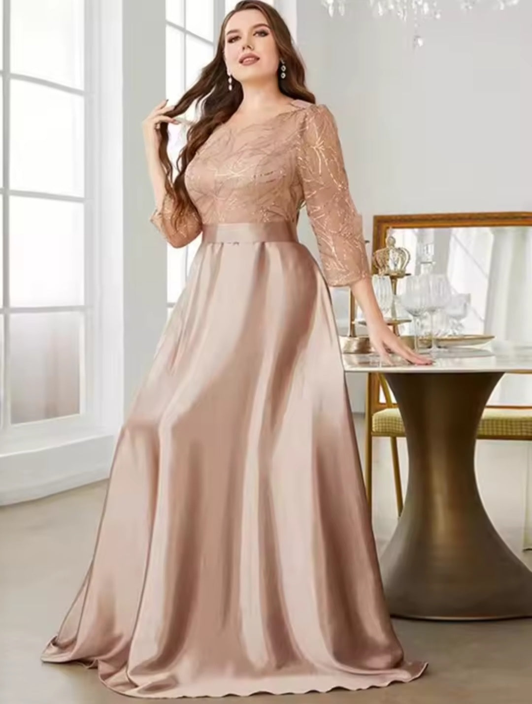 Woman wearing a long, elegant dress in a well-lit room.