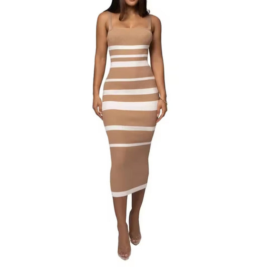 Woman wearing a beige and white striped dress on a white background