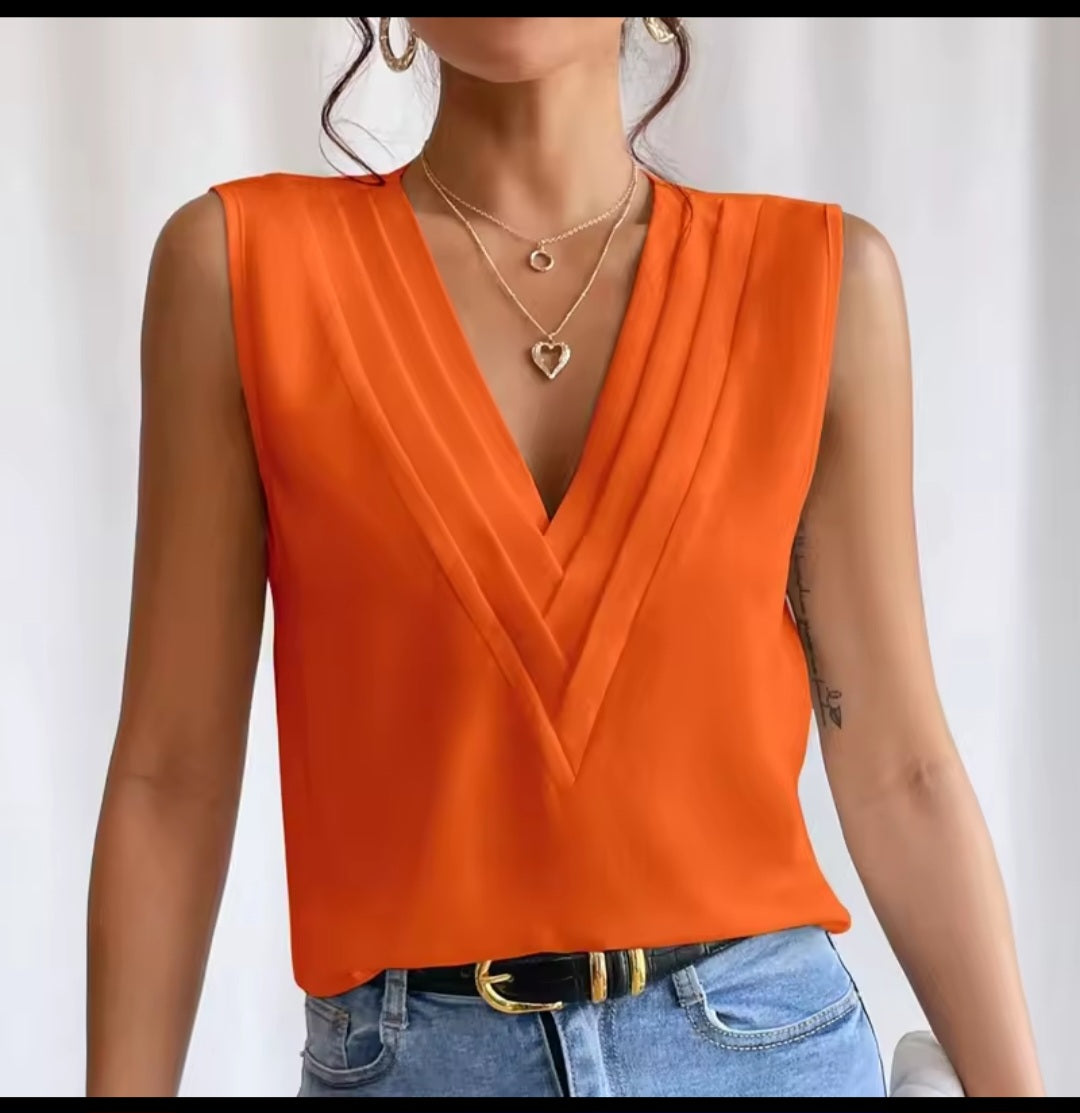 Orange sleeveless top worn by a person on a white background