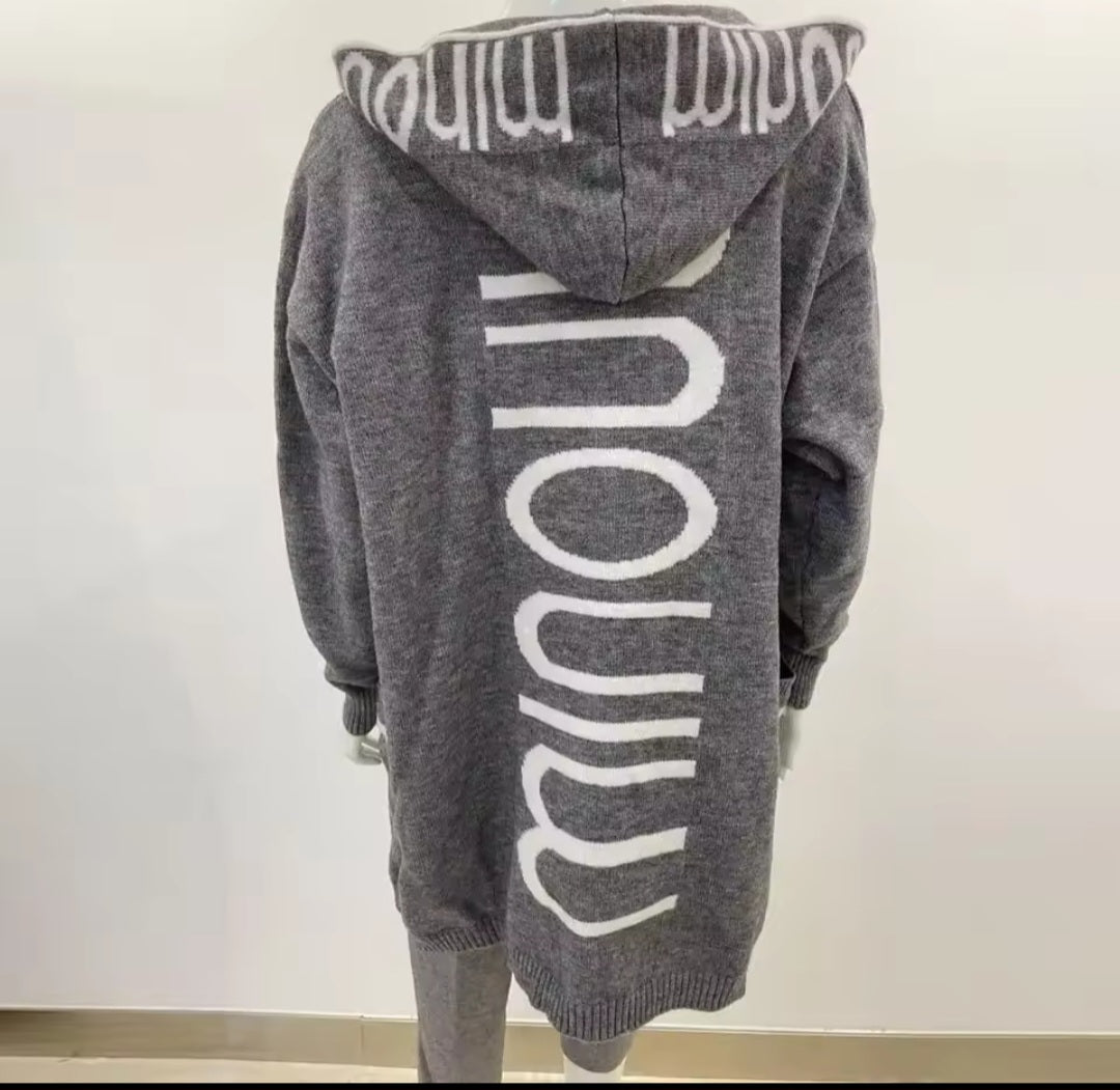 Gray hoodie with 'minou' branding on the back against a white background