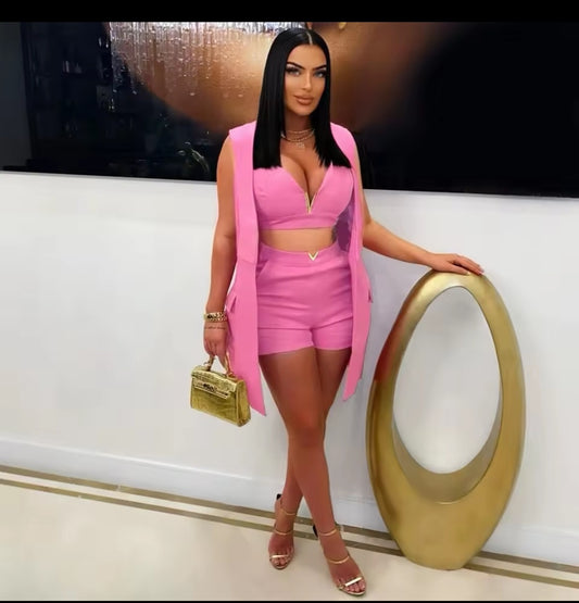 Woman in a pink outfit posing in a stylish interior setting