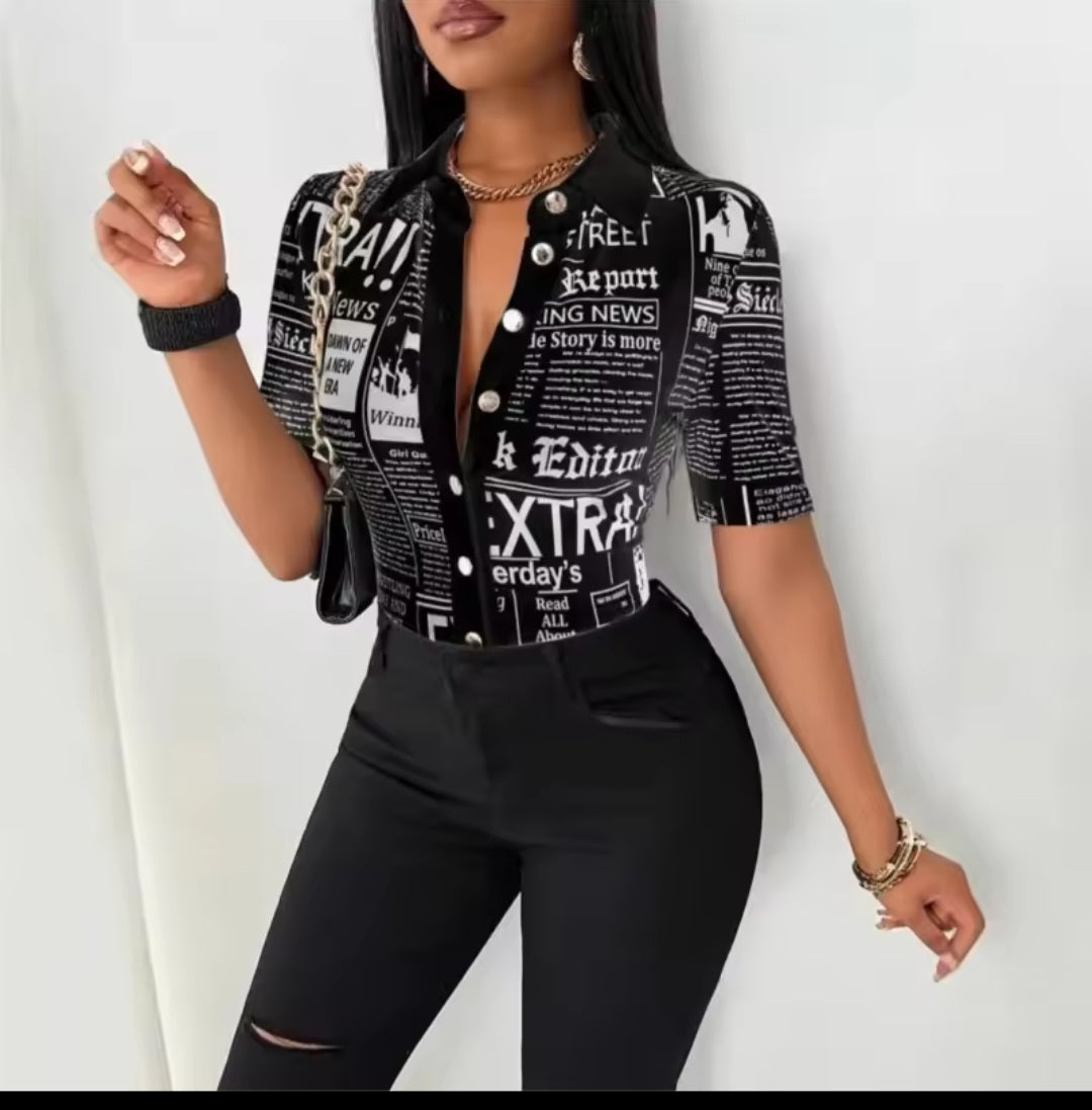 Woman wearing a black and white patterned top with black pants on a white background