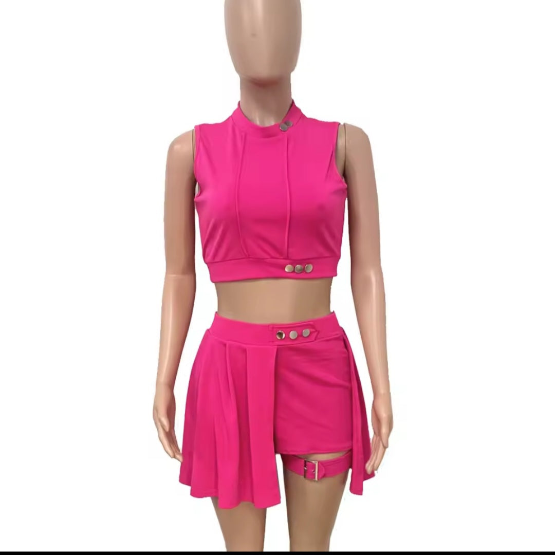 Mannequin wearing a bright pink outfit with a top and skirt on a white background