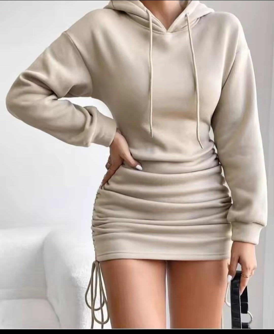 Beige hoodie and skirt set on a plain background