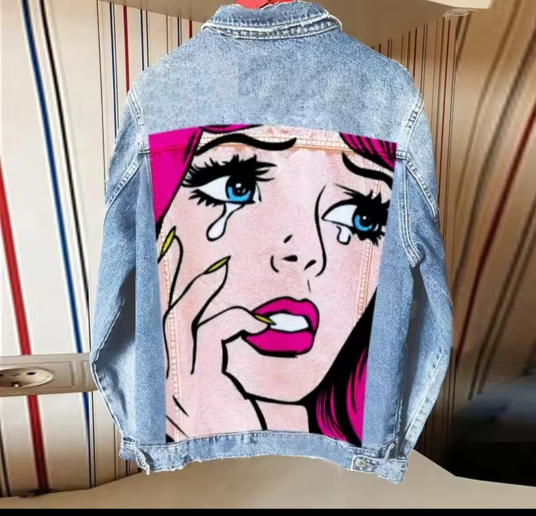 Denim jacket with a graphic design of a woman's face on a striped background