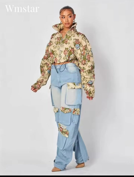 Person wearing a floral hoodie and patchwork jeans on a white background