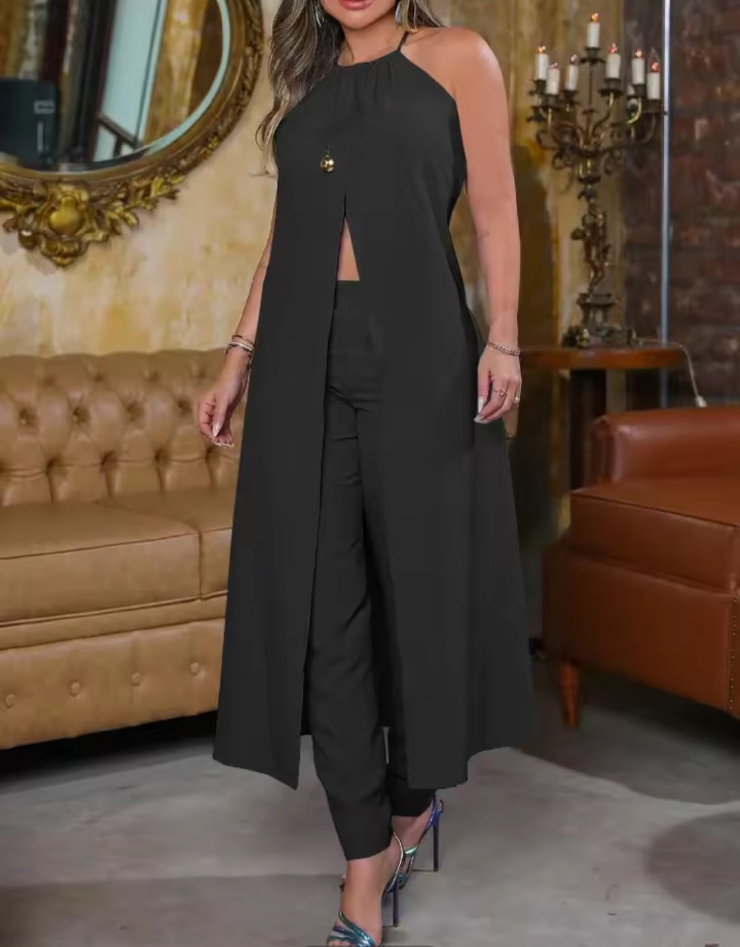 Woman wearing a black outfit in a room with brown furniture.