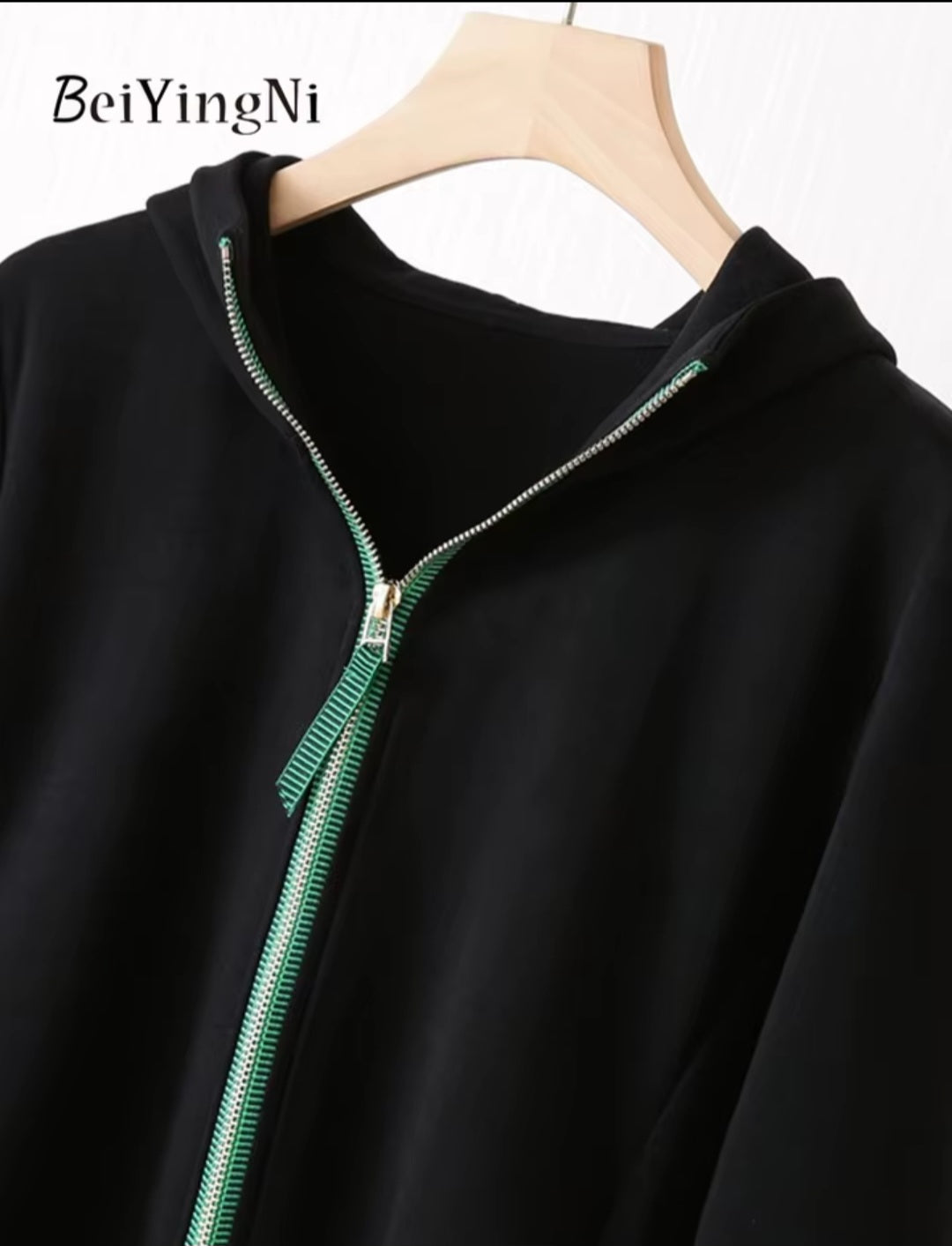 Black jacket with a green zipper on a hanger, branded 'BeiYingNi'.