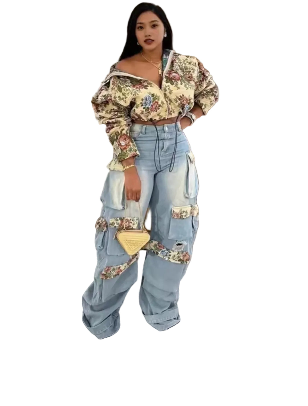 Person wearing a floral top and light blue jeans with decorative elements in an indoor setting.