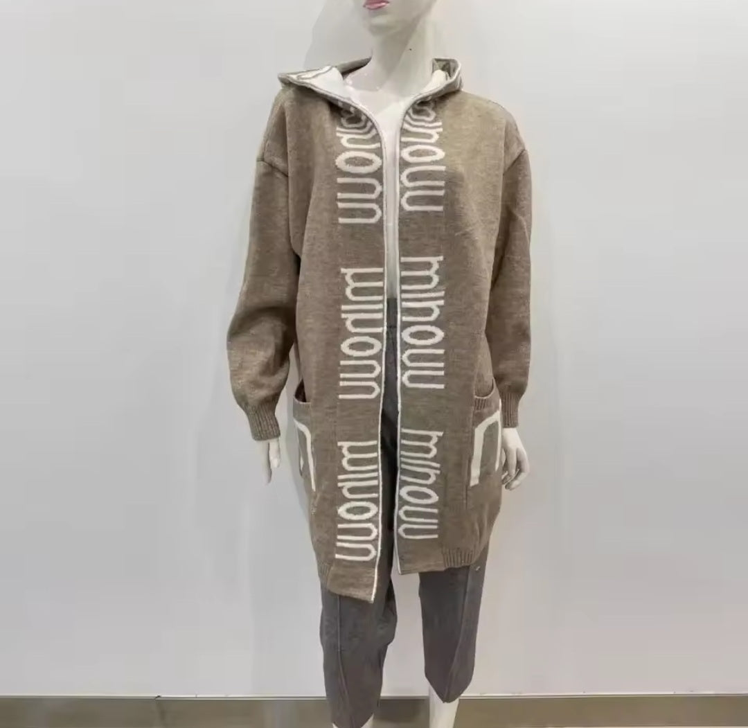 Mannequin wearing a brown cardigan with white text on a plain background