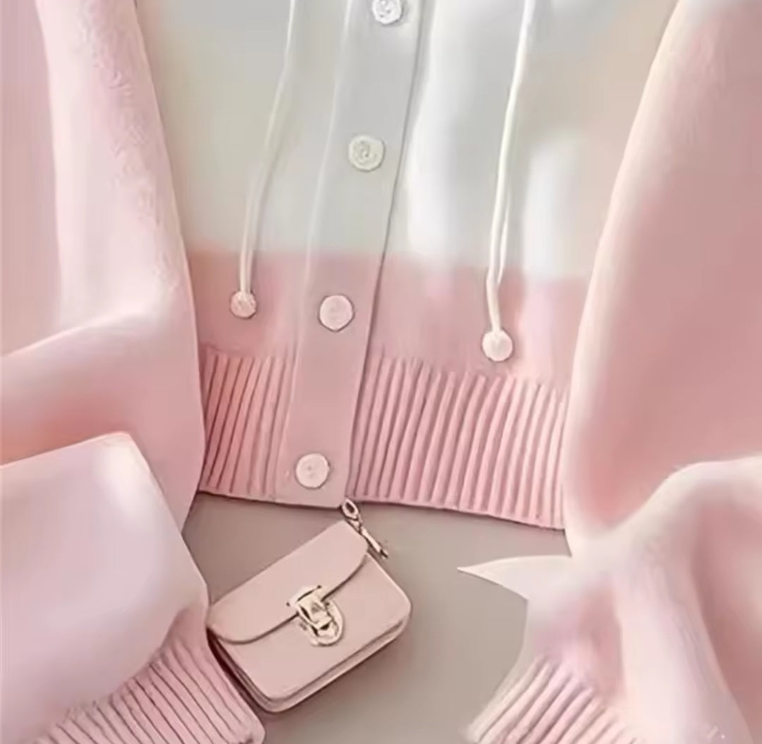 Pink cardigan with a matching handbag on a light background
