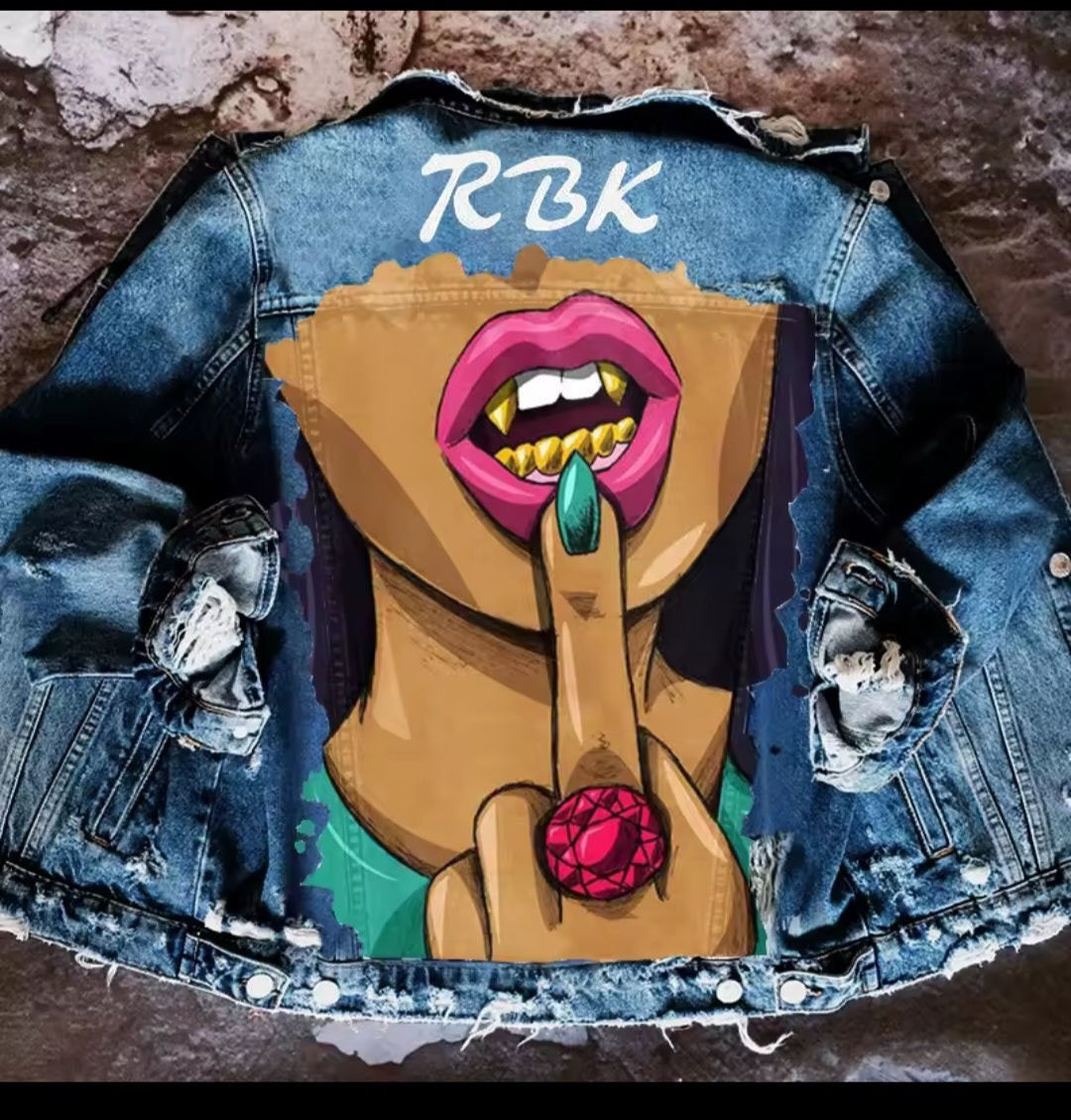 Denim jacket with a graphic design of a stylized face and 'RBK' text on a textured background