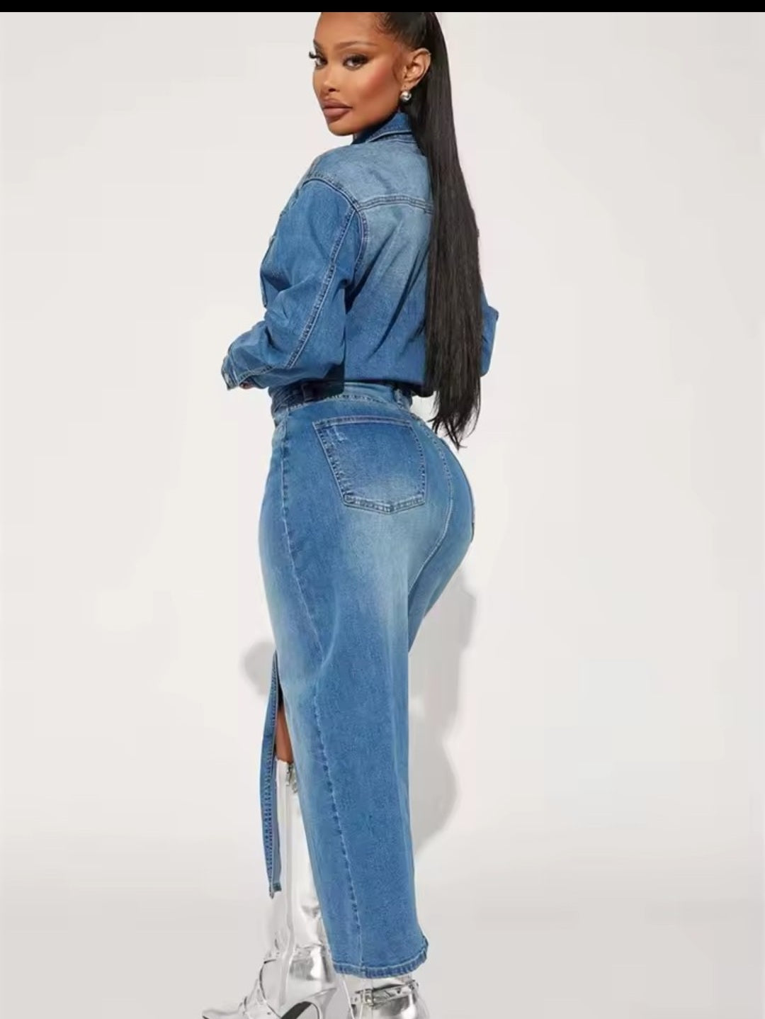 Person wearing a blue denim outfit with a white background