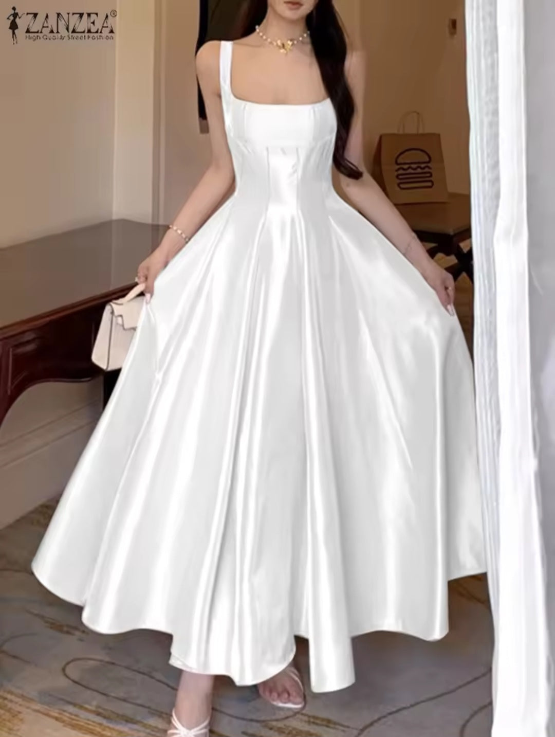 Woman wearing a white dress in an indoor setting