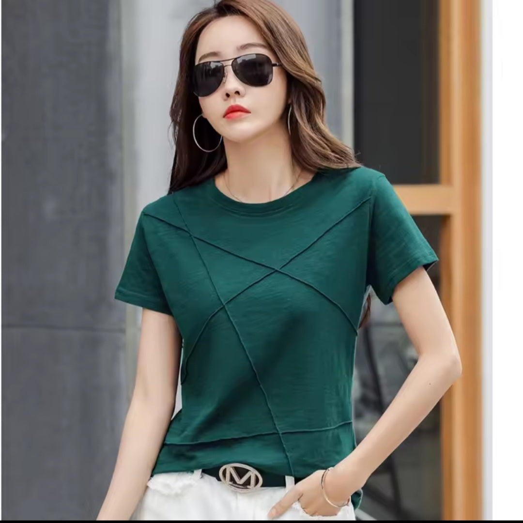 Woman wearing a green top with criss-cross design in an urban setting